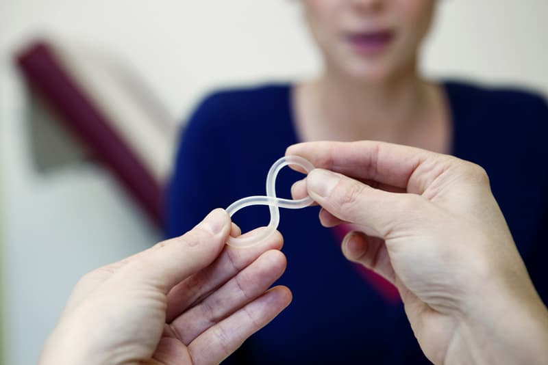 Contraceptive vaginal ring being held up