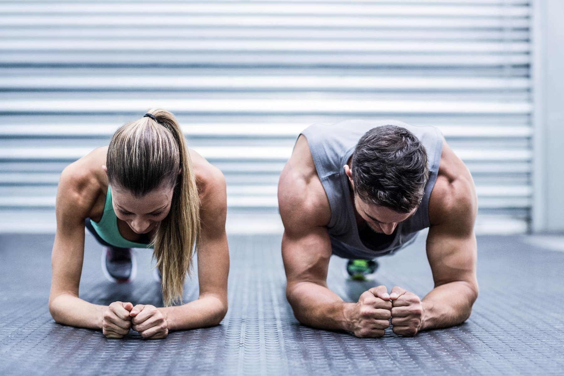 A man and a woman planking next to each other