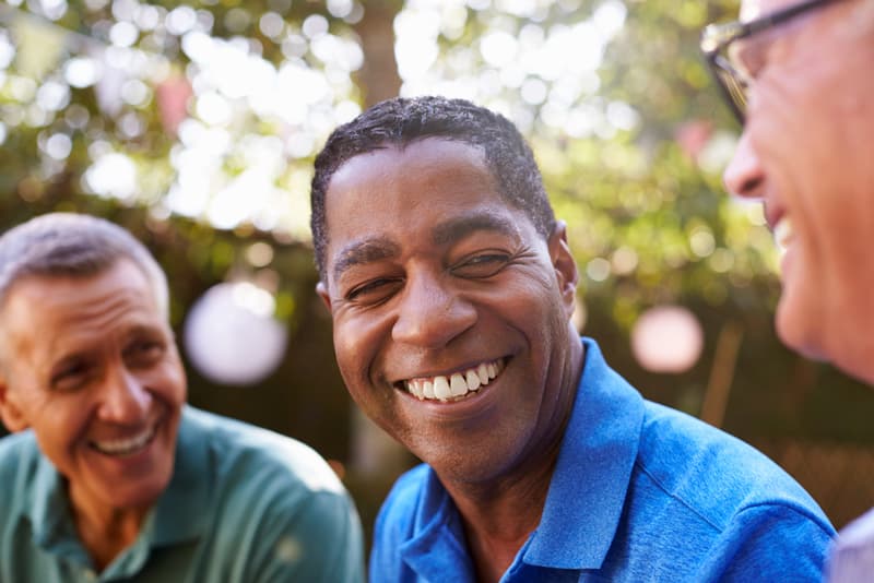 3 middle aged men laughing together