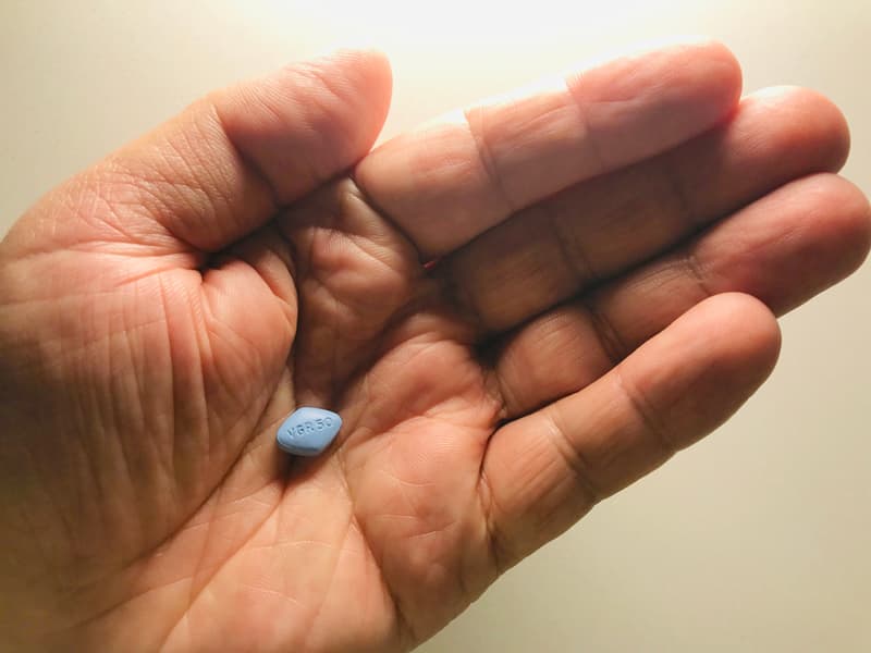 The blue pill (Viagra) in a hand