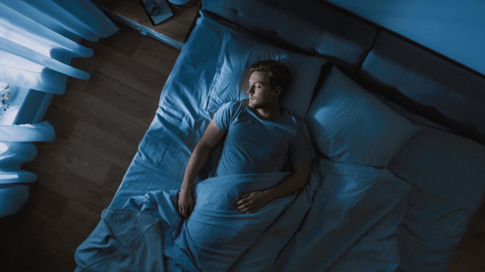 A man lying in bed sleeping