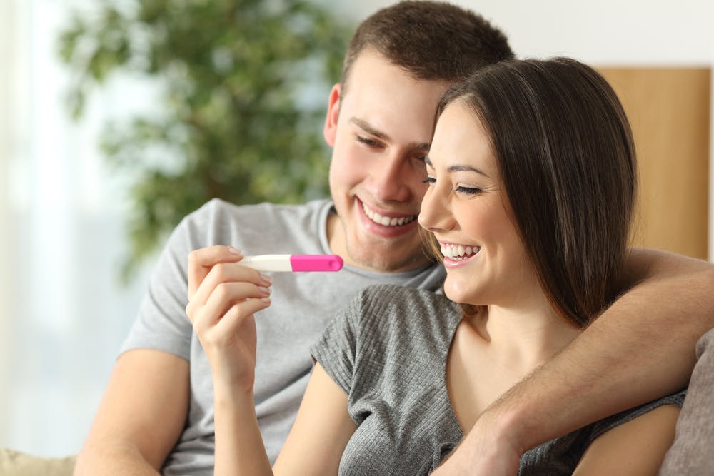 A couple looking happy because they have a positive pregnancy test