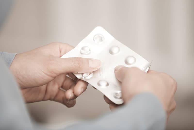 A blister pack of painkillers being held