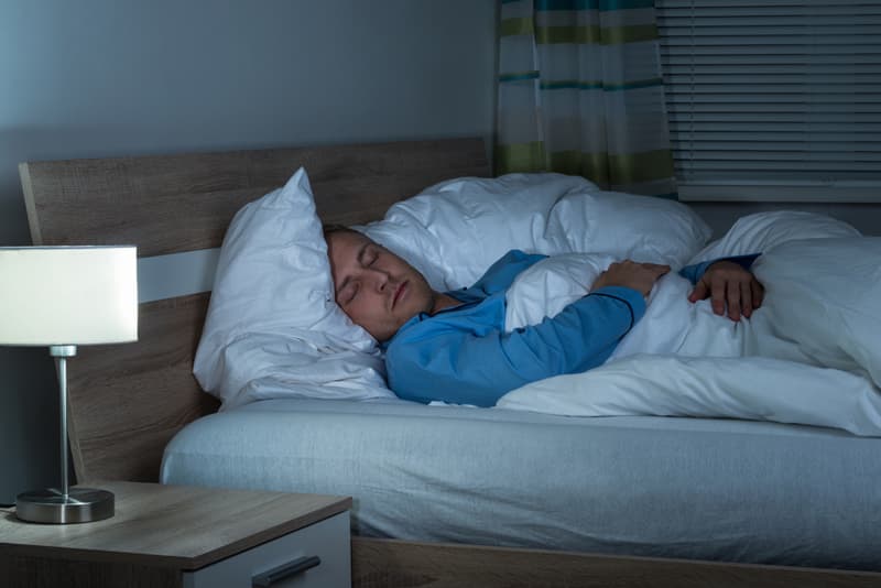 A man sleeping on his bed