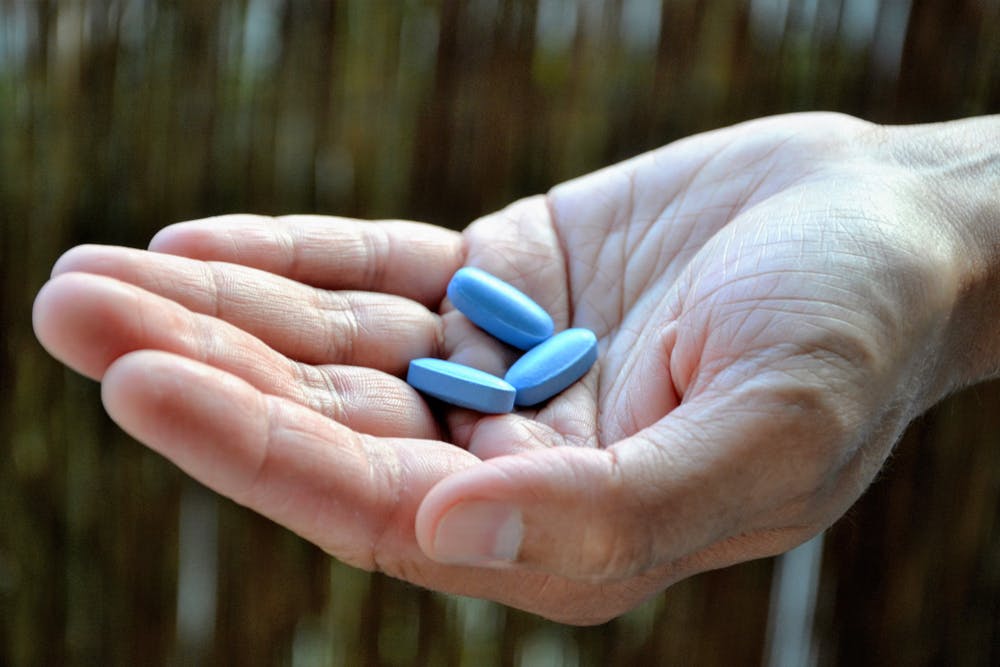 Viagra tablets being held in a hand