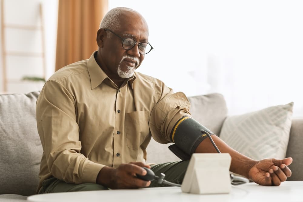 Elderly man checking his blood pressure