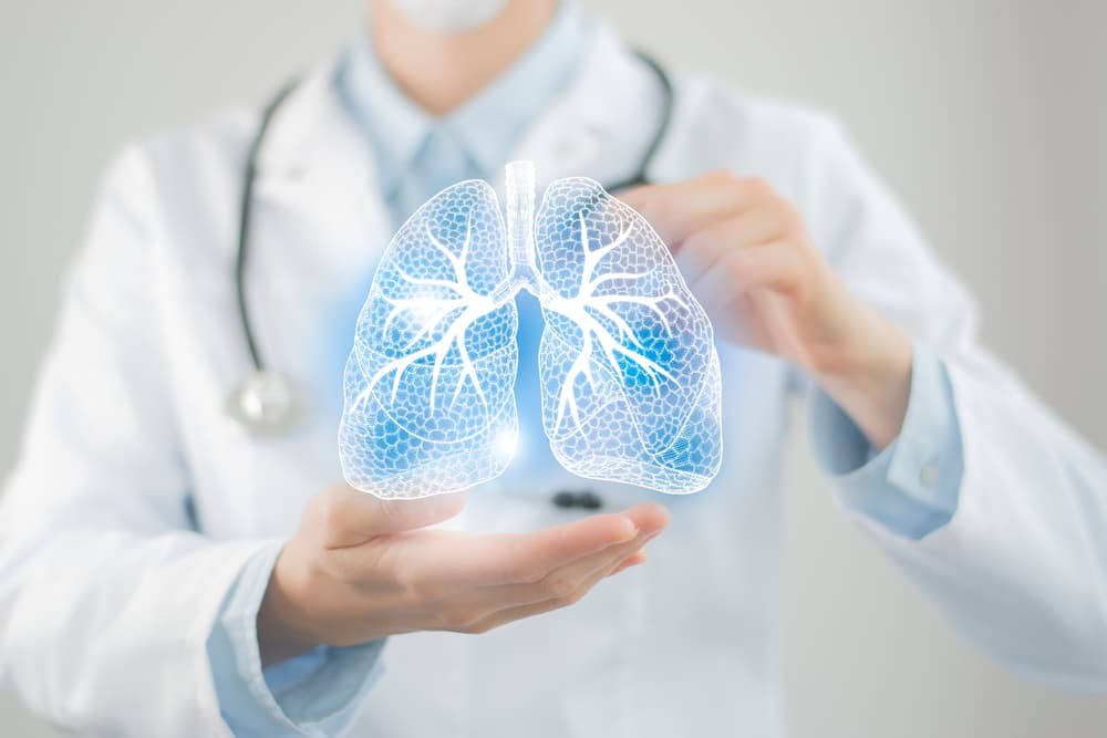 Doctor holding a set of holographic lungs in their hands to indicate COPD