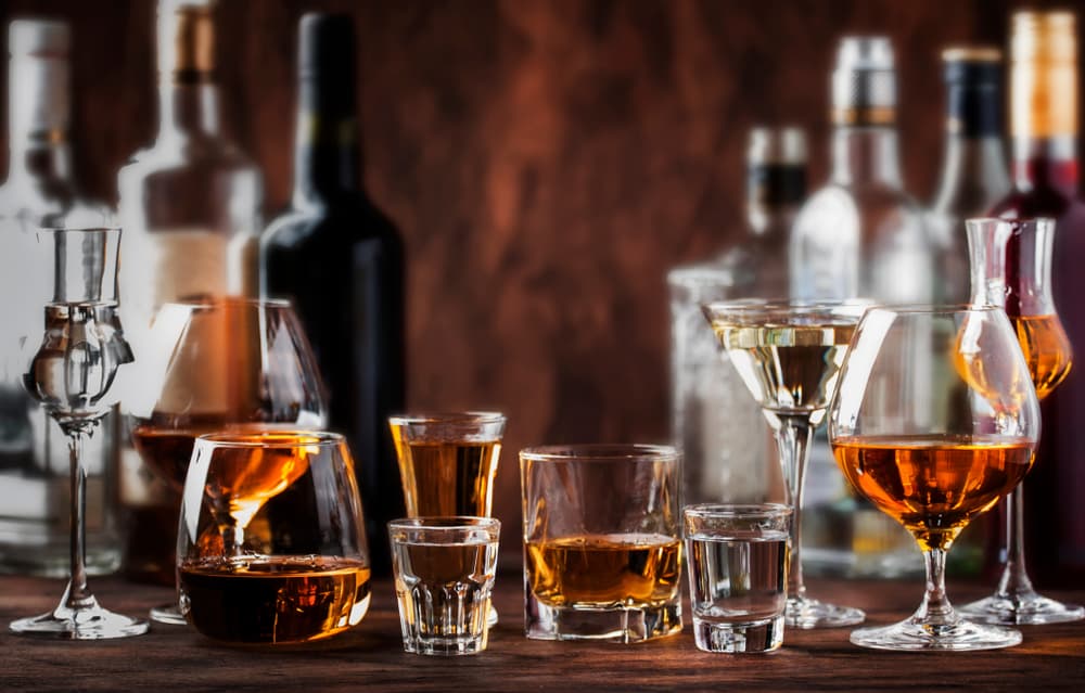 Alcohol in various glasses spread across a table