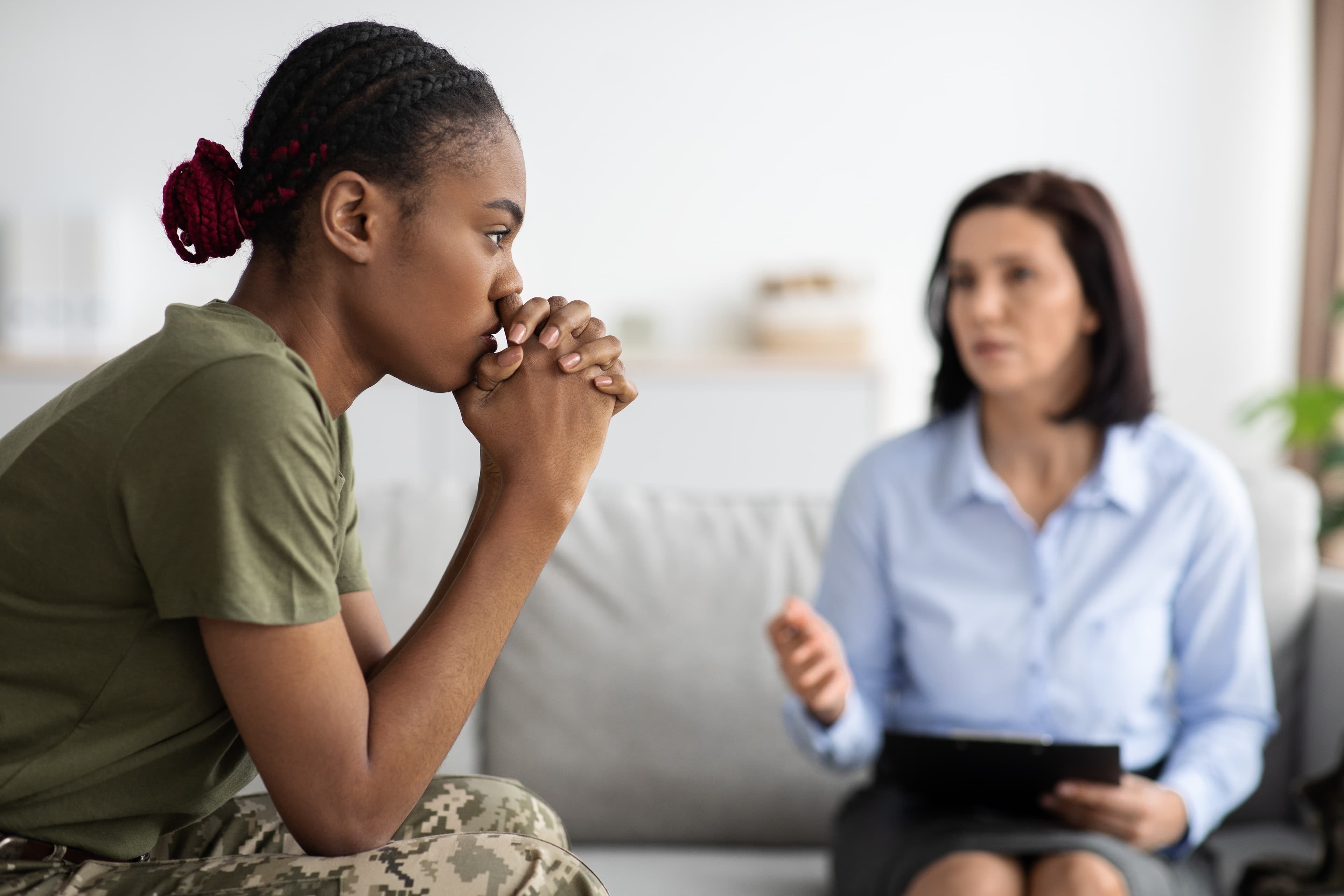 A therapist consulting a former soldier patient who is suffering from PTSD