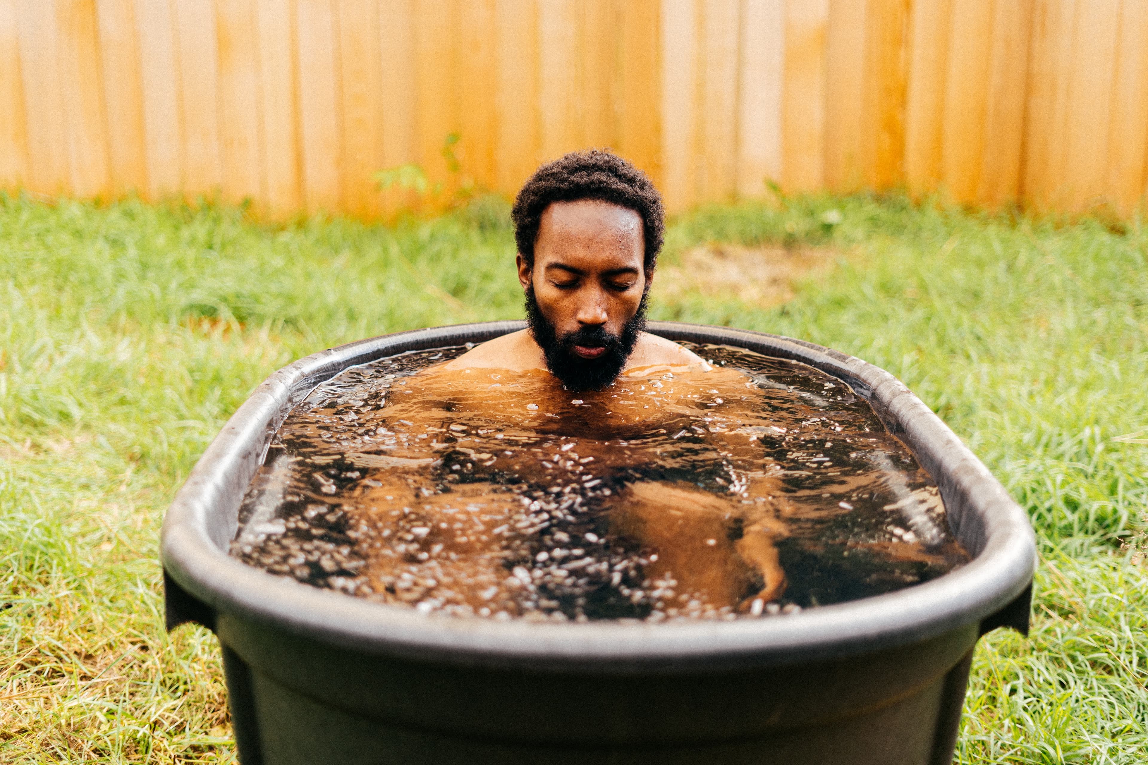 A man sat in an ice bath