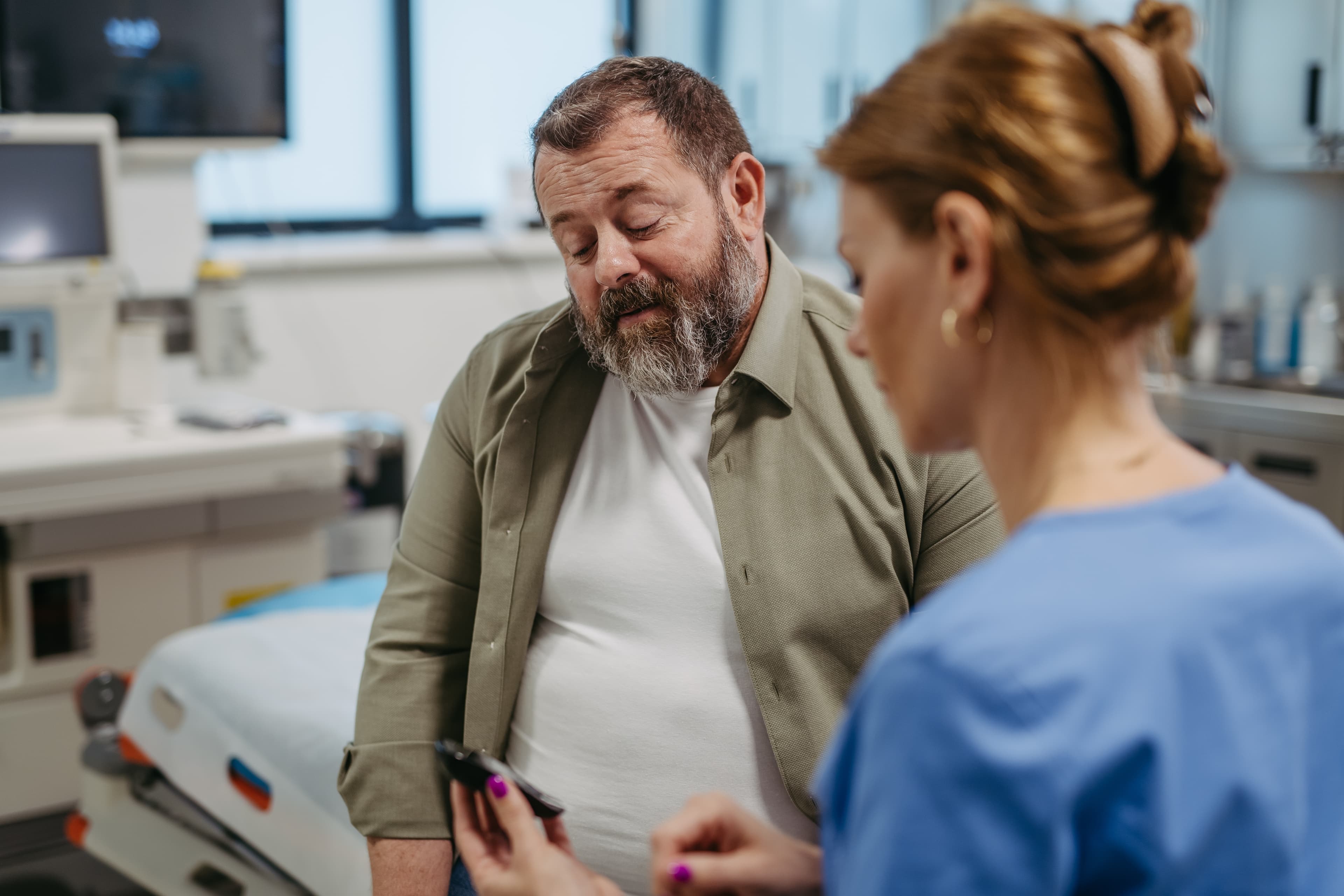 An overweight man consulting a doctor abour managing their weight