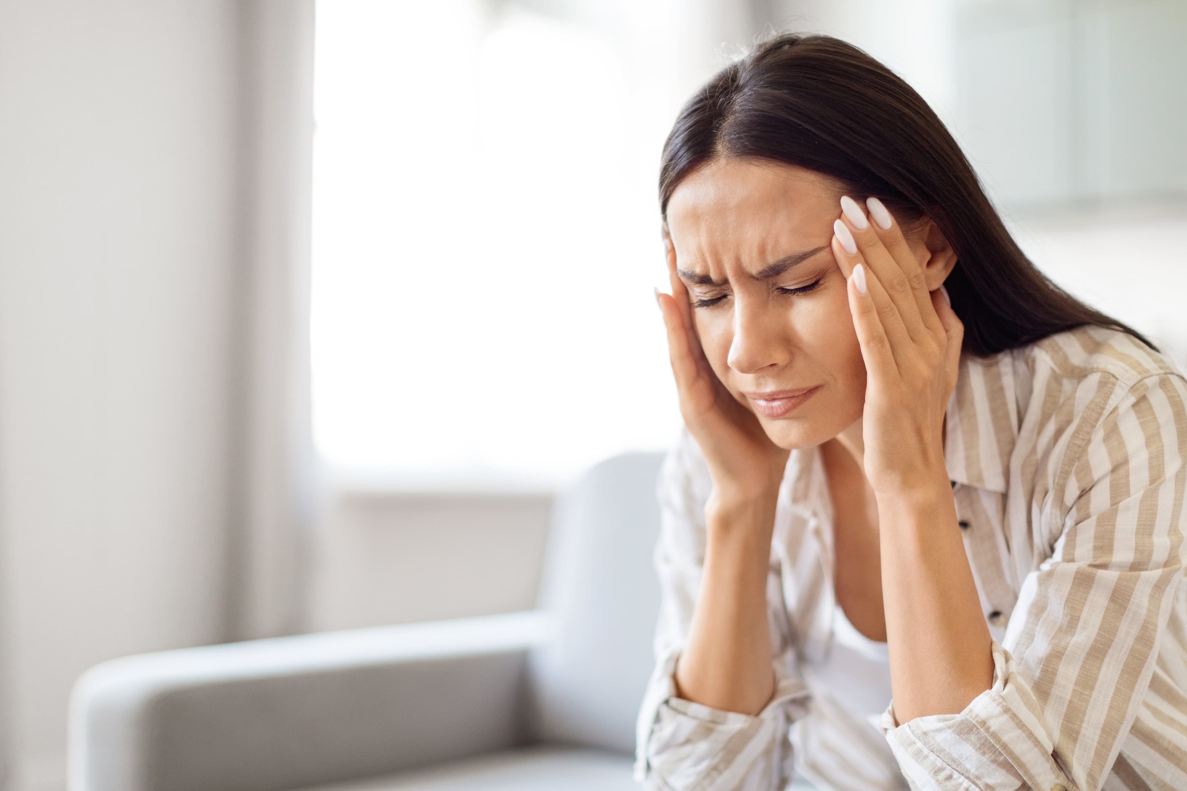 A lady suffering with a migraine